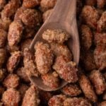 Candied almonds on a wooden spoon.