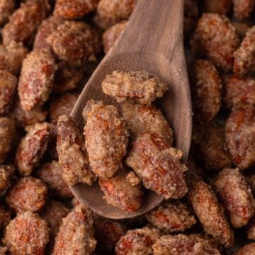 Candied almonds on a wooden spoon.
