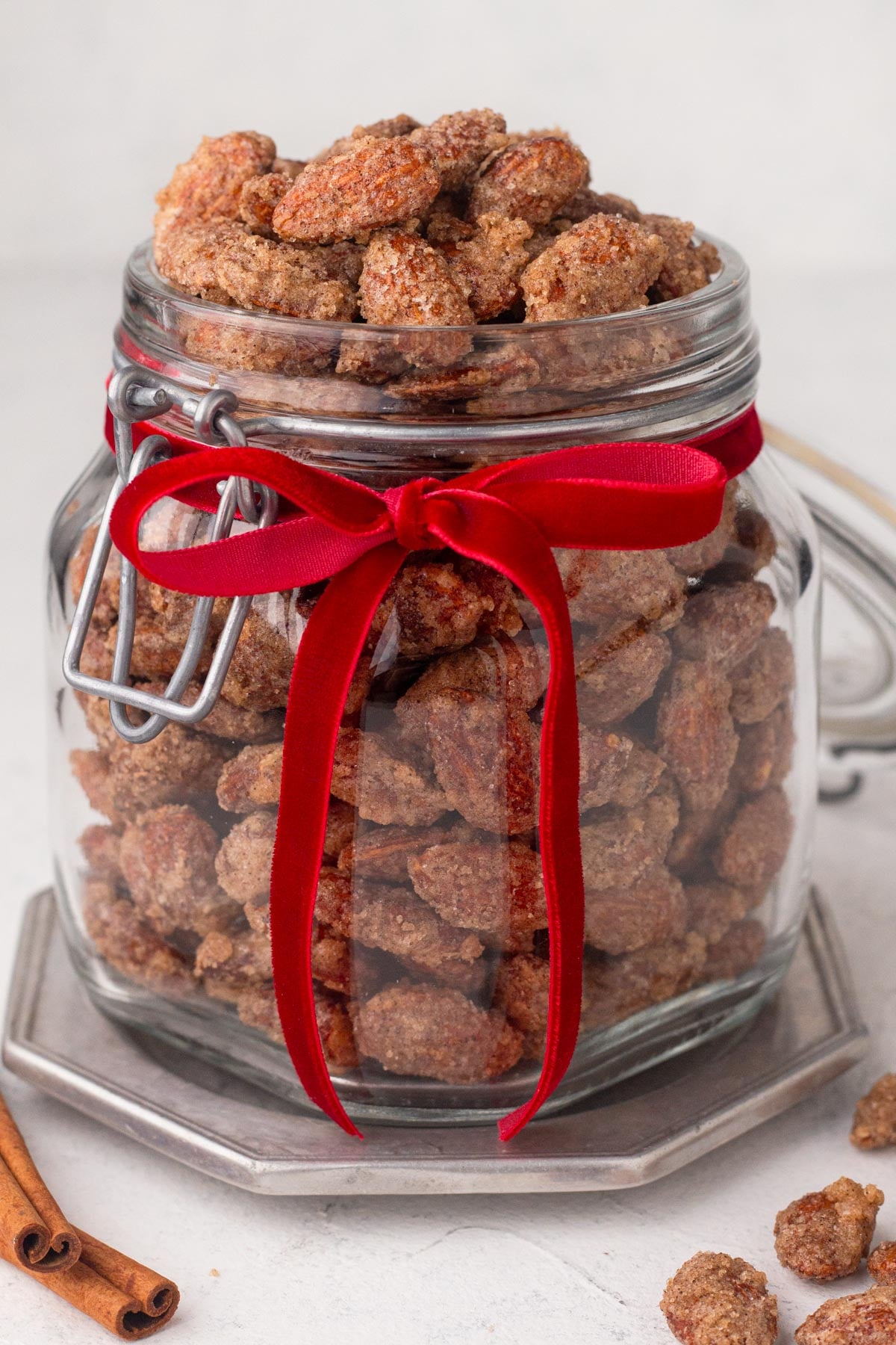 Candied almonds in a glass jar with a red velvet ribbon.