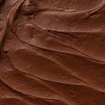 Close-up view of chocolate frosting spread on top of a cake.