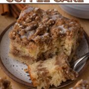 A slice of coffee cake on a white speckled plate with a text overlay.