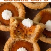 A bitten sugar cookie cup with pumpkin pie filling and whipped cream with a text overlay.
