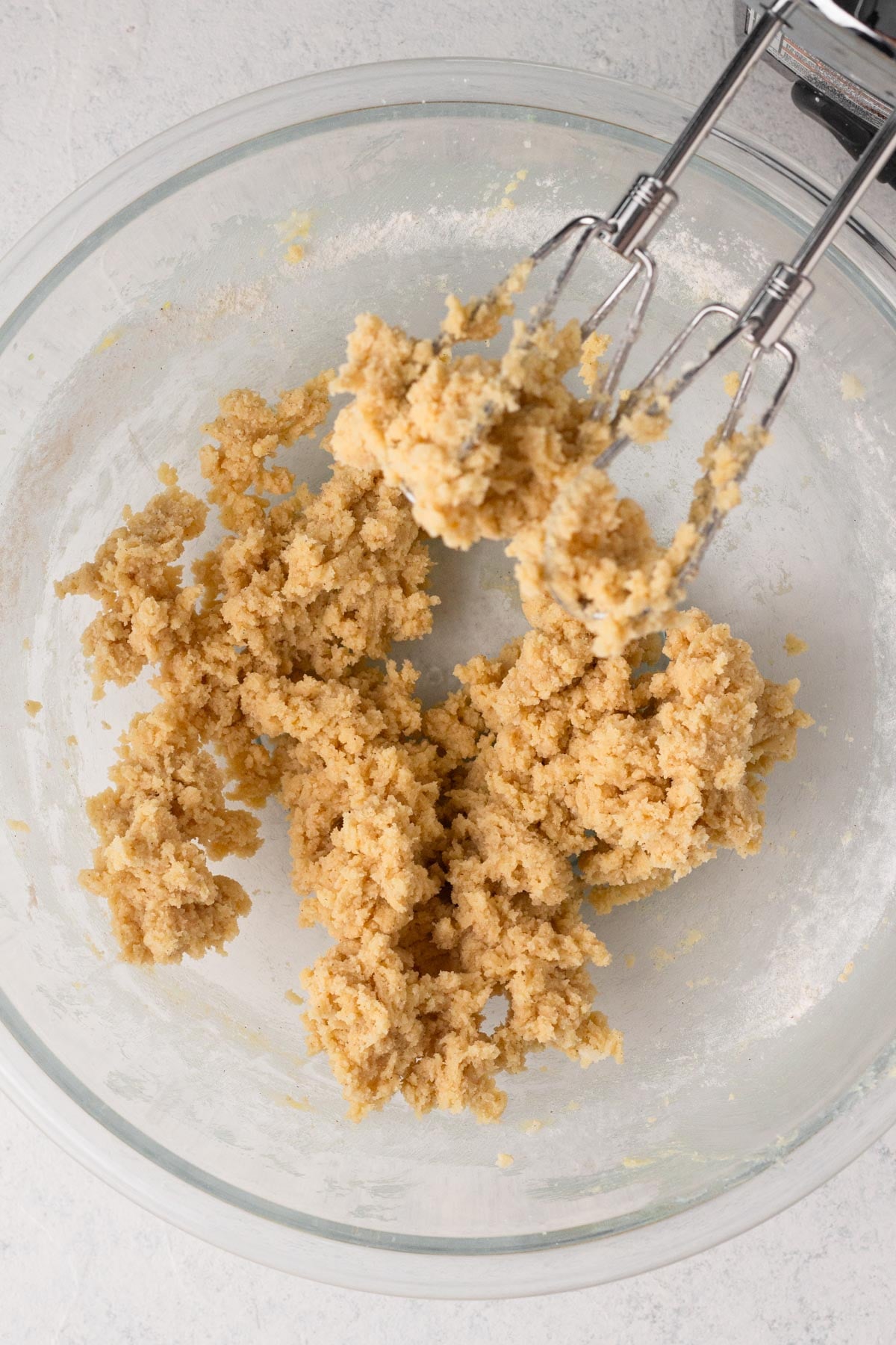 Sugar cookie dough in a glass mixing bowl.