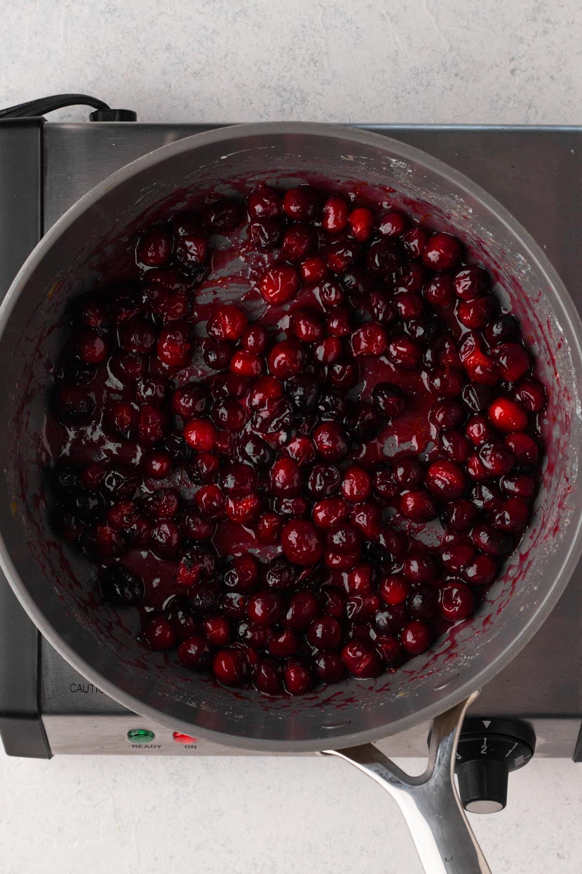 Cranberry filling cooked in a saute pan.
