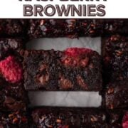 Side view of a chocolate brownie with fresh raspberries with a text overlay.